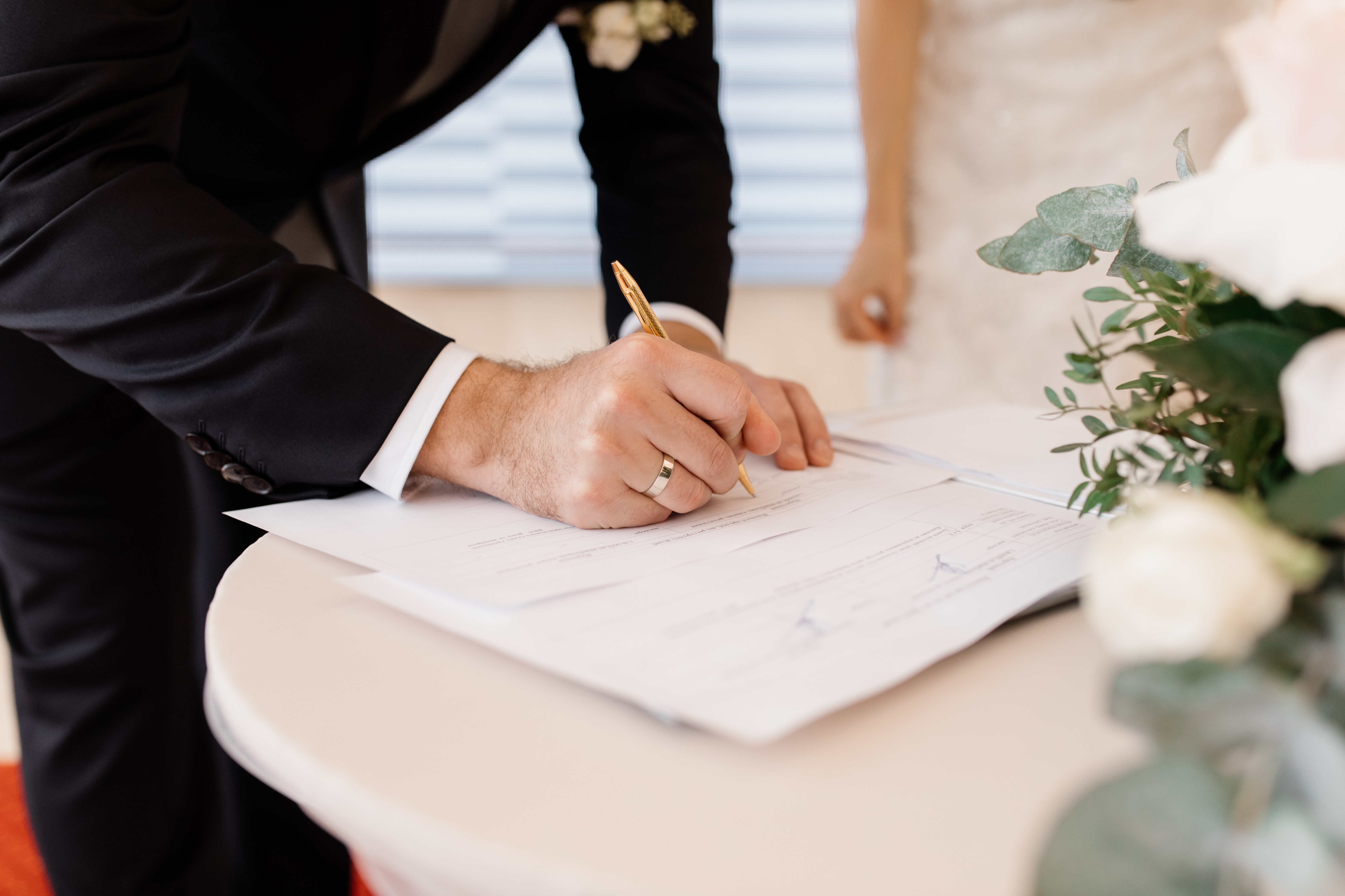 couple-love-is-signing-official-marriage-documents